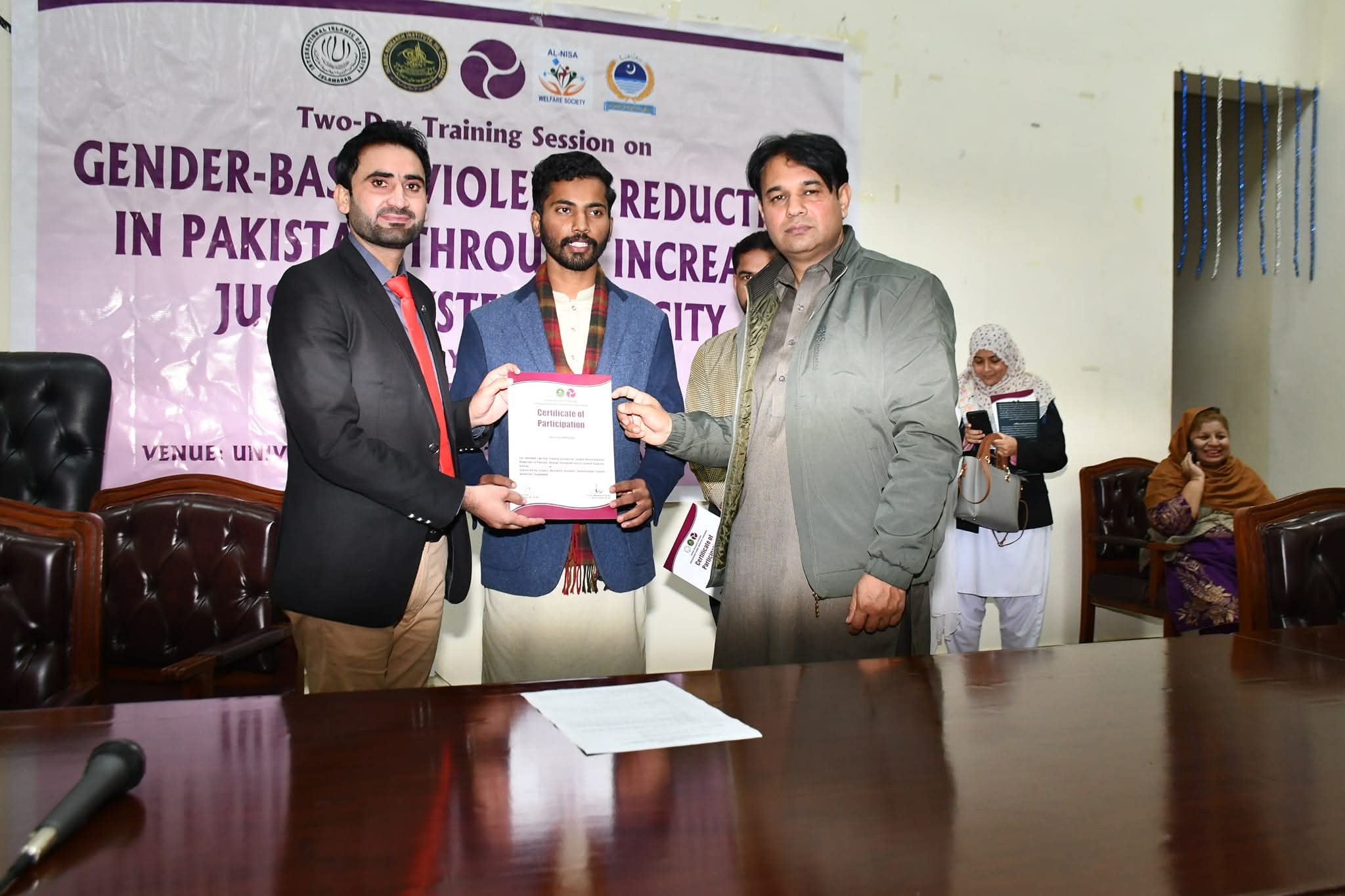 Al-Nisa CEO giving certificates to participants at a two-day gender-based violence reduction training session.